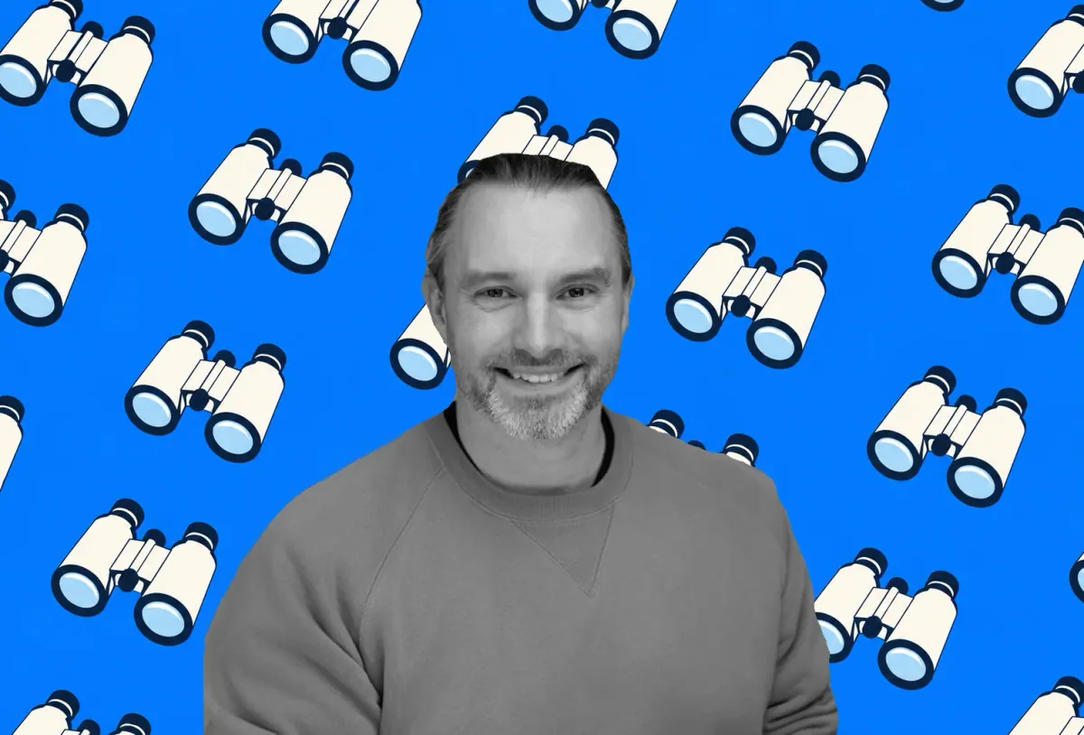 Sean Betts against a blue background patterned with binoculars.