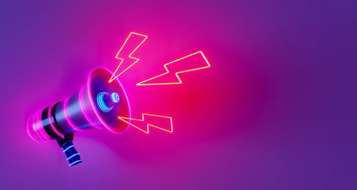 A neon megaphone glowing against a purple and pink background.