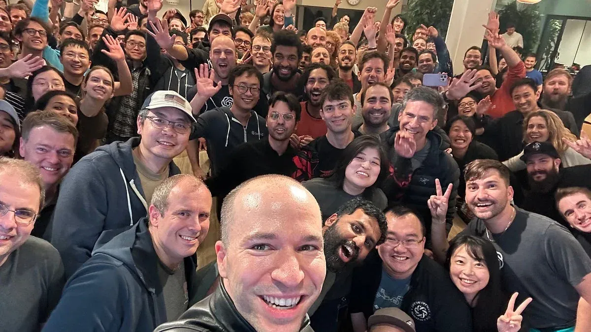 A group photograph of the OpenAI team.