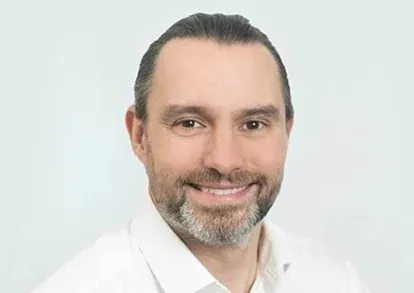 Portrait of Sean Betts wearing a white shirt.